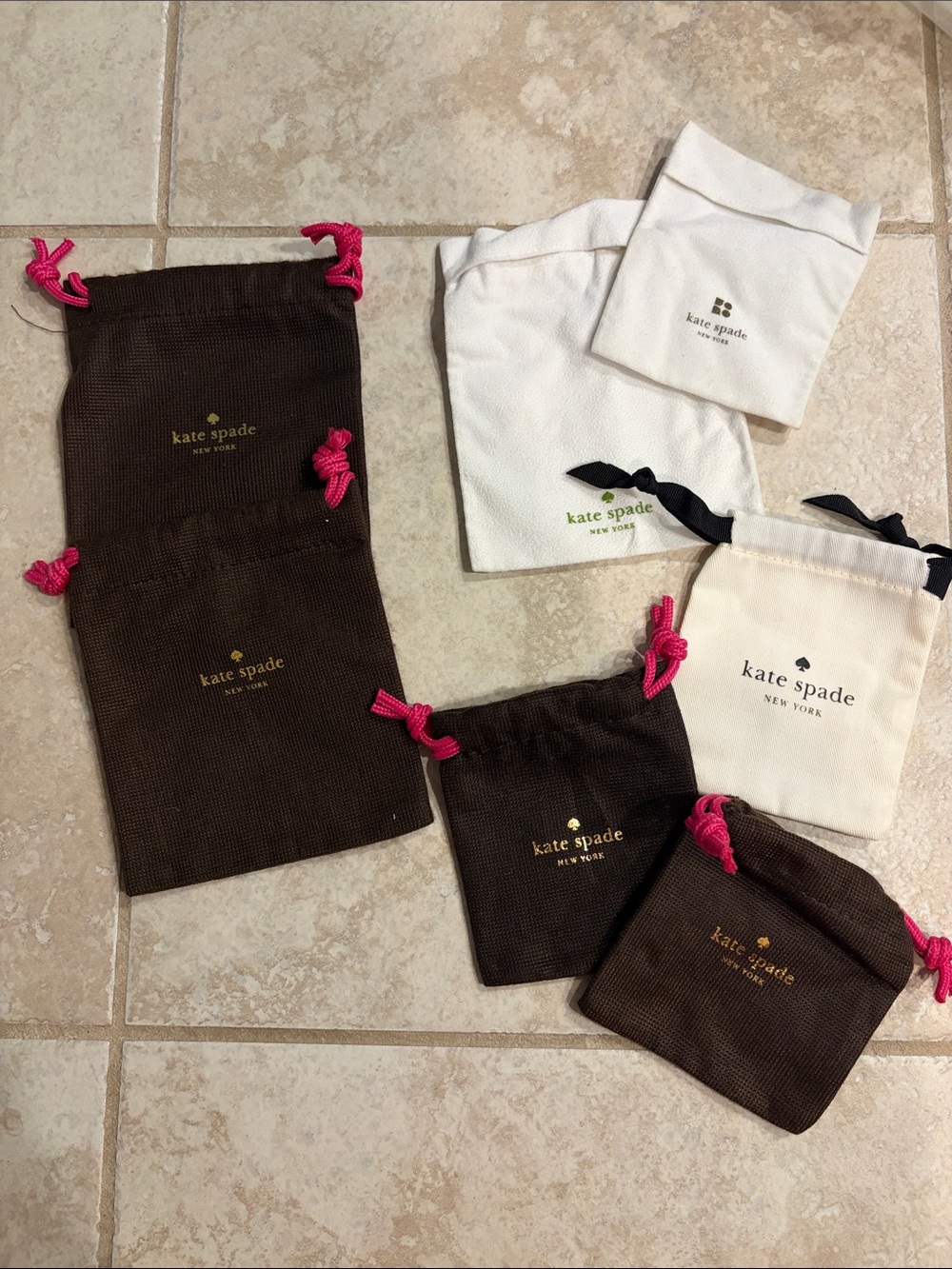 kate spade jewelry dust bags. Set of 7  Pouches in various sizes.